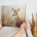 Framed canvas print of an impressionist painting of a deer with warm earthy tones