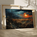 Framed canvas print of a dramatic sunset over a rustic meadow with vivid warm tones