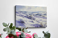 Framed canvas print of a serene winter landscape with snow-covered hills and valleys