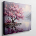 Framed canvas print of a cherry blossom tree by a tranquil lake at dusk with mountains in the background, reflecting soft pink and purple hues