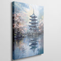 Framed canvas print of a traditional Japanese pagoda and cherry blossoms beside a reflective lake