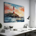 Framed canvas print of a vibrant sunset seascape with a red and white lighthouse on a cliff