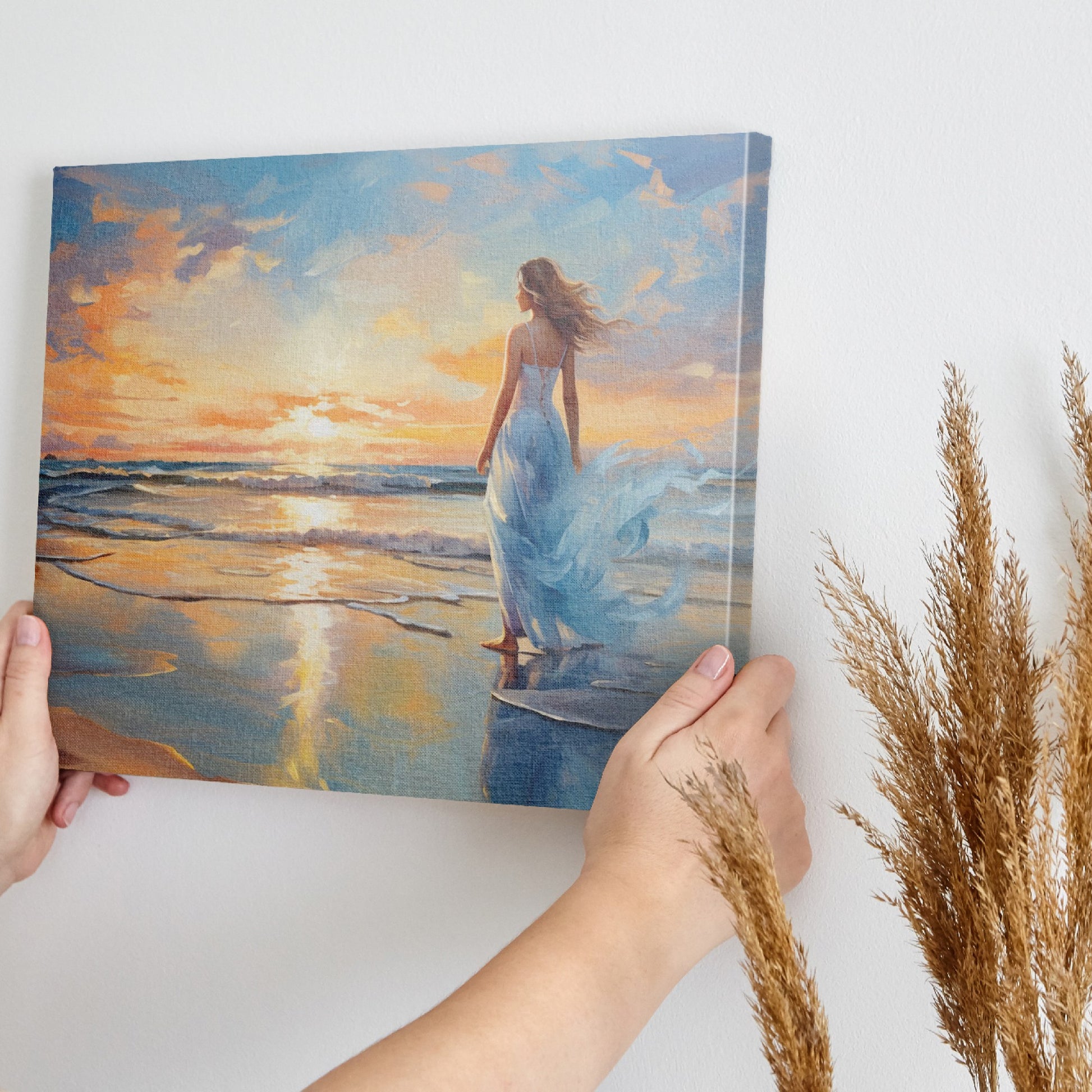 Framed canvas print of a woman in an elegant dress at sunset on a beach, with vibrant reflection in water