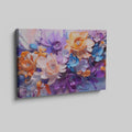 Framed canvas print of vibrant impasto-style abstract flowers in orange, lavender, and blue