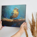 Framed canvas print of a vibrant blue and golden bird on branch with impasto texture