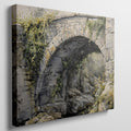 Framed canvas print of a rustic stone bridge with ivy in watercolour style