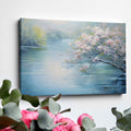 Framed canvas print of serene riverscape with cherry blossoms in impressionist style