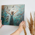 Framed canvas print of a woman joyfully embracing surrounded by impressionist styled birds