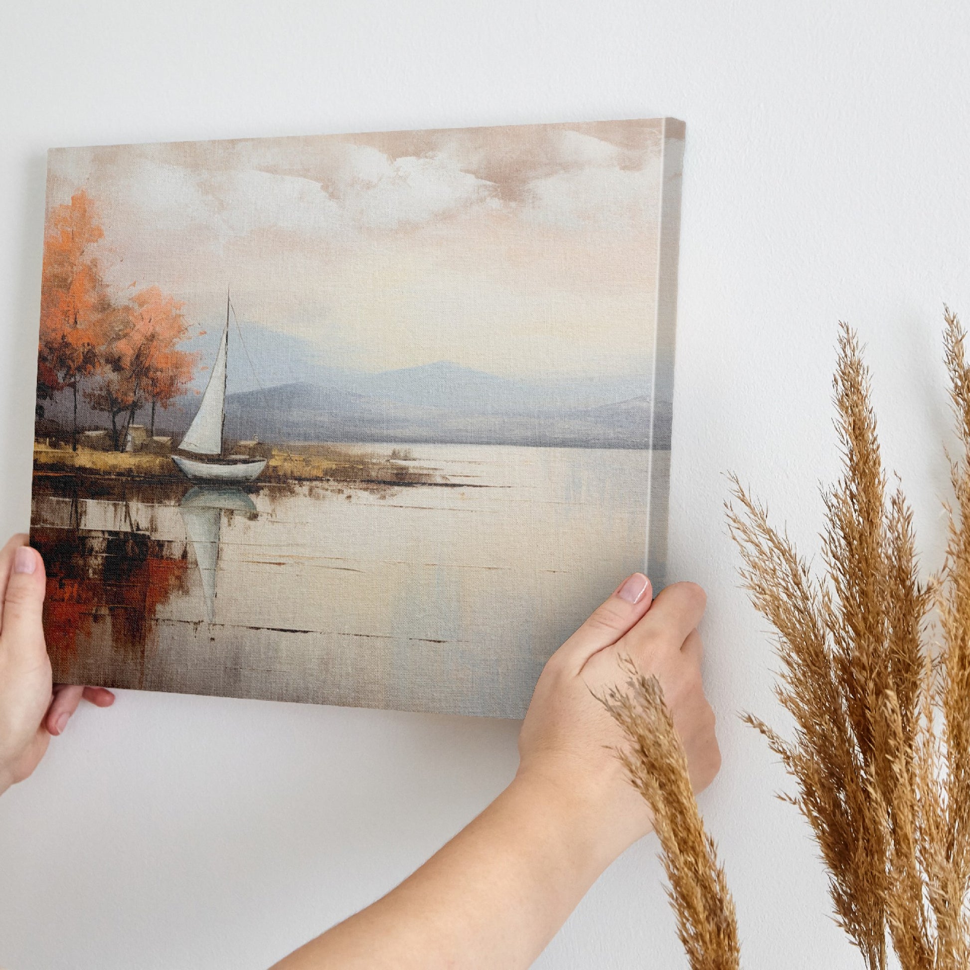 Framed canvas print of an impressionist painting with a sailing boat and autumn trees by a lake