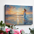 Framed canvas print of a woman in an elegant dress at sunset on a beach, with vibrant reflection in water