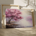 Framed canvas print of an impressionistic cherry blossom tree by a tranquil lake with soft pastel colors