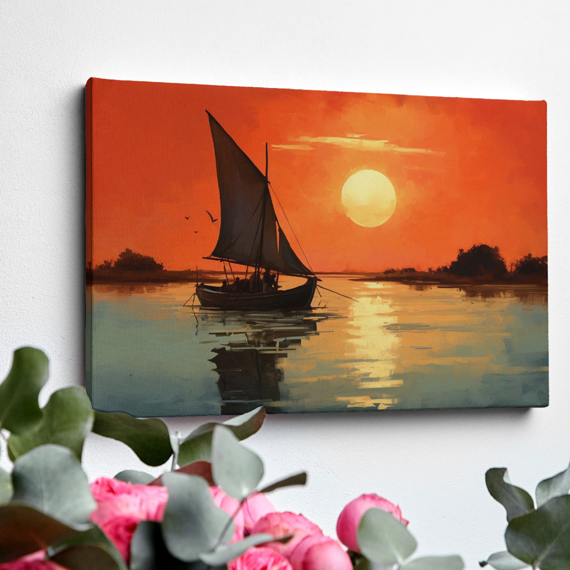 Framed canvas print of a sailboat against an orange sunset with water reflections