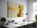 Framed canvas print of a Golden Buddha statue sitting in meditation by the water