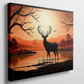 Printed canvas art of a black deer silhouette against an orange sunset with trees and mountains