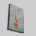 Framed canvas print of a vibrant sailboat against a pastel sunset sky reflected on tranquil ocean waters