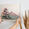 Framed canvas print of a tranquil mountain landscape with pastel colours and cherry blossoms