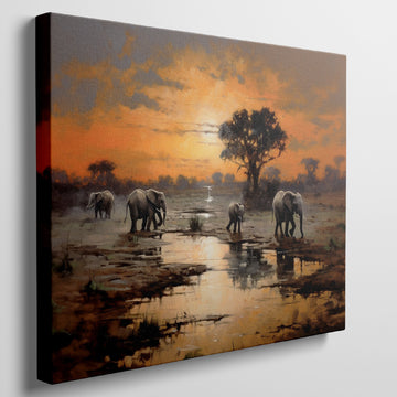 Framed canvas print of African elephants walking beside water during a vibrant sunset