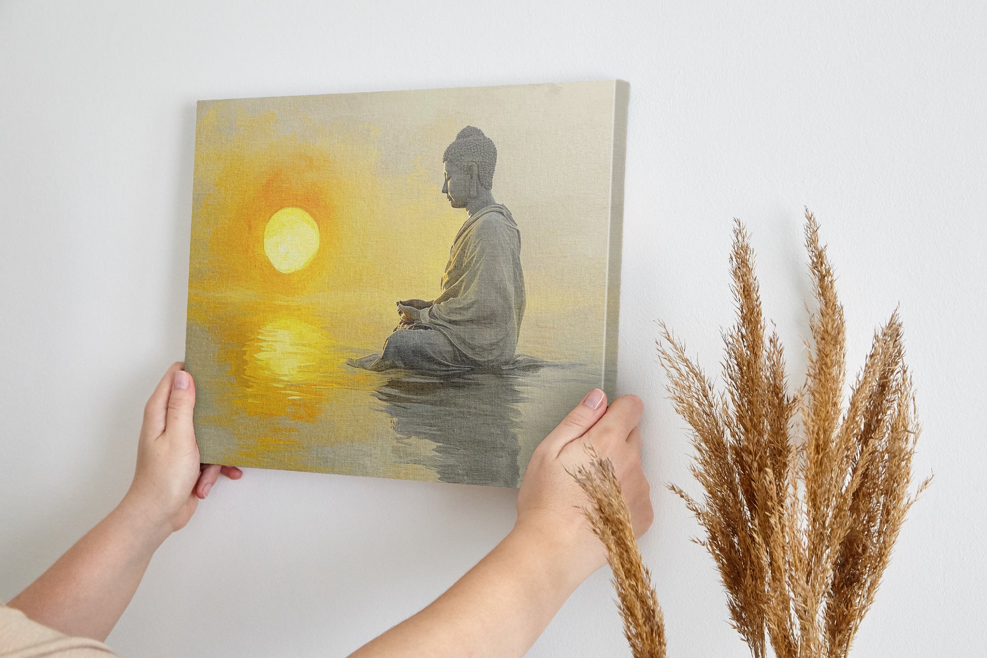 Framed canvas print of a meditative figure with the sun setting over water, reflecting golden tones