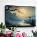 Framed canvas print of a serene Oriental landscape with a meditative figure under a tree against a sunrise backdrop