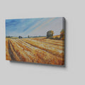 Framed canvas print of golden wheat fields under a blue sky in a rural landscape