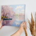 Framed canvas print of a serene river scene with cherry blossoms and a small boat