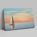 Sailboat on calming ocean waters during a vibrant sunset with orange and pink clouds in the sky.