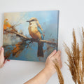 Framed canvas print of a vibrant impressionistic bird perched on a branch with abstract autumn background