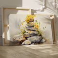 Framed canvas print of watercolour stones stacked with yellow flowers