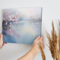 Framed canvas print of cherry blossoms over a tranquil lake with soft pastel colours and a pair of ducks