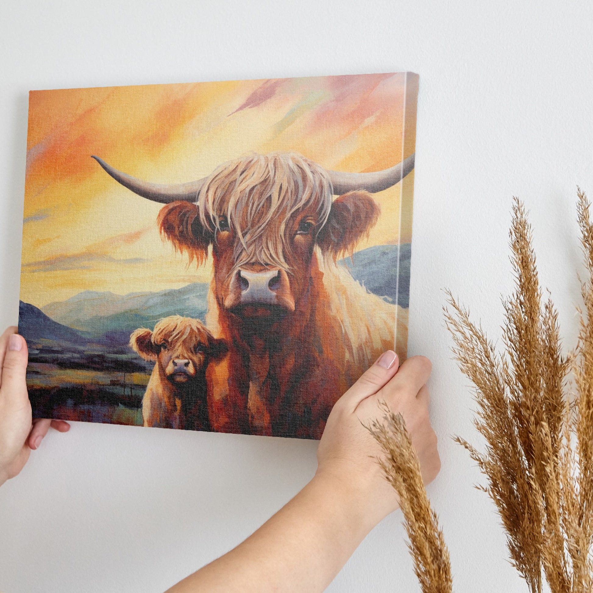 Framed canvas print of Highland cattle with calf at sunset, warm tones and mountain backdrop