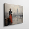 Framed canvas print of an elegant woman overlooking a misty cityscape with a red dress as a focal point