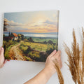 Framed canvas print of a rustic farmhouse and path leading to a sunset over the sea