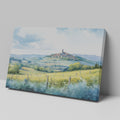 Framed canvas print of a Tuscan landscape with watercolor rolling hills and a village