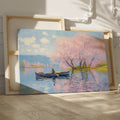 Framed canvas print of Impressionist-style cherry blossoms over a lake with a rowboat