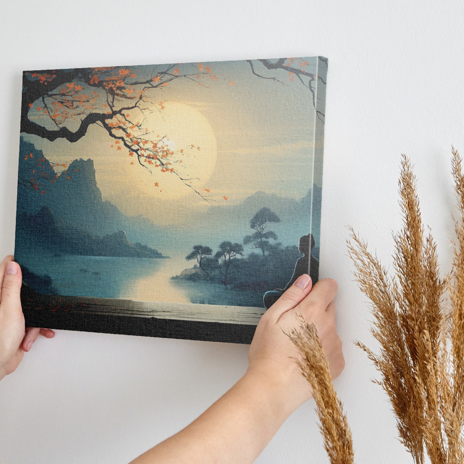 Framed canvas print of a serene Oriental landscape with a meditative figure under a tree against a sunrise backdrop