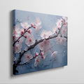 Framed canvas print of cherry blossoms with rain droplets on blue background