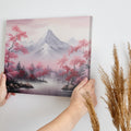 Framed canvas print of serene mountain landscape with pink cherry blossoms and mist