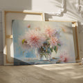 Framed canvas print of delicate dahlias in a glass vase with a soft pastel palette