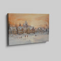 Framed canvas print of a snowy Victorian village at sunset with people ice skating