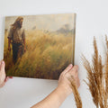 Framed canvas print of a man walking through a golden wheat field during sunset with a rustic feel