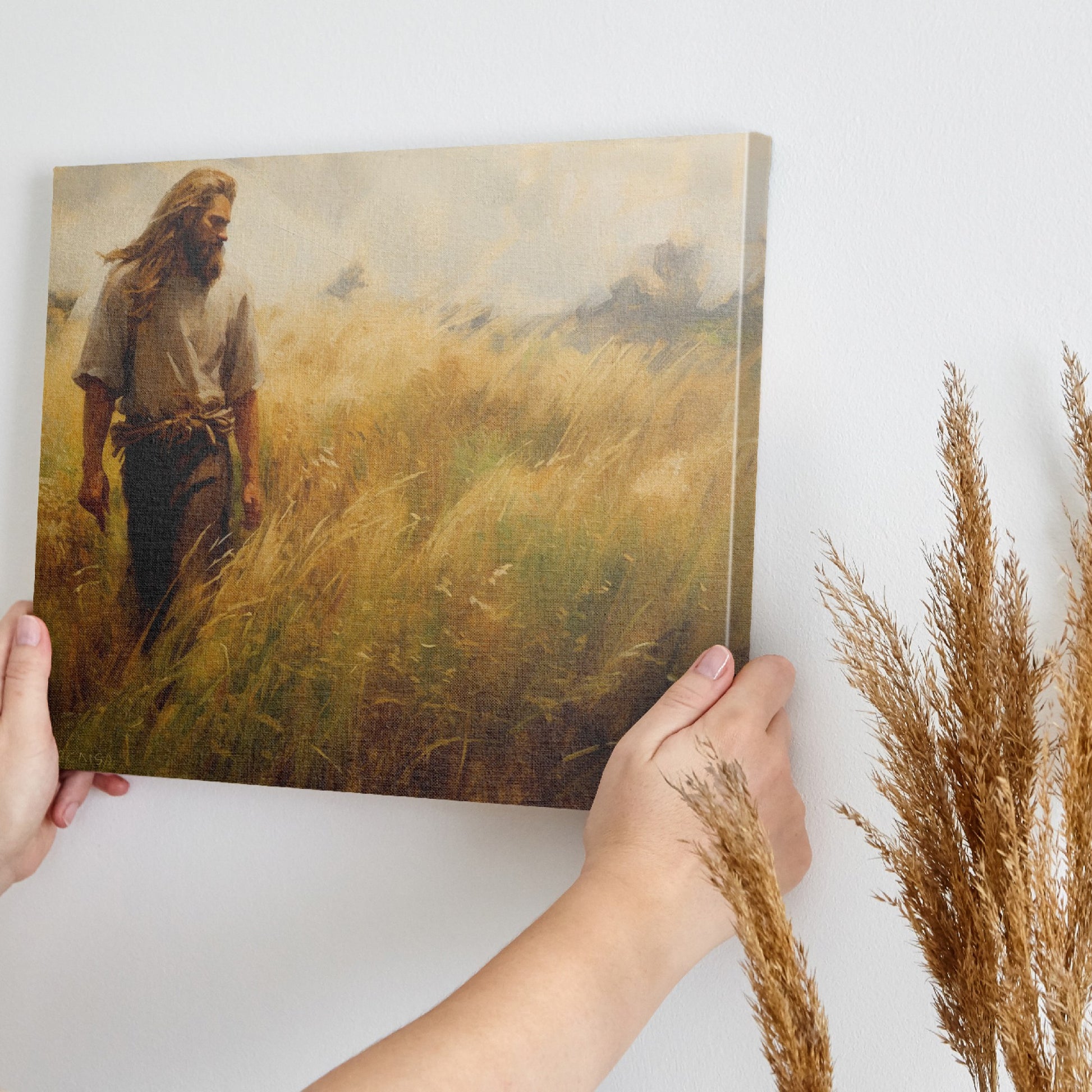 Framed canvas print of a man walking through a golden wheat field during sunset with a rustic feel