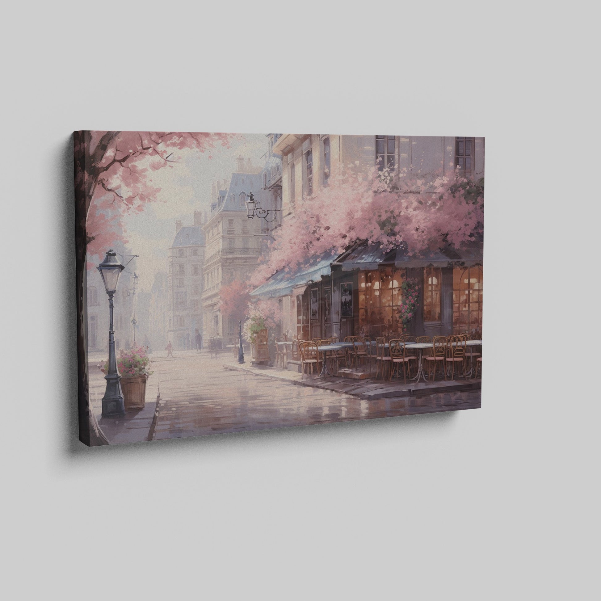 Framed canvas print of a Parisian cafe on a cobblestone street with cherry blossoms in full bloom