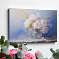 Framed canvas print of elegant pink peonies in an ornate glass vase portrayed with soft pastel colors