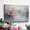 Framed canvas print depicting impressionist art of blossoming trees by a misty lake with soft pastel colours