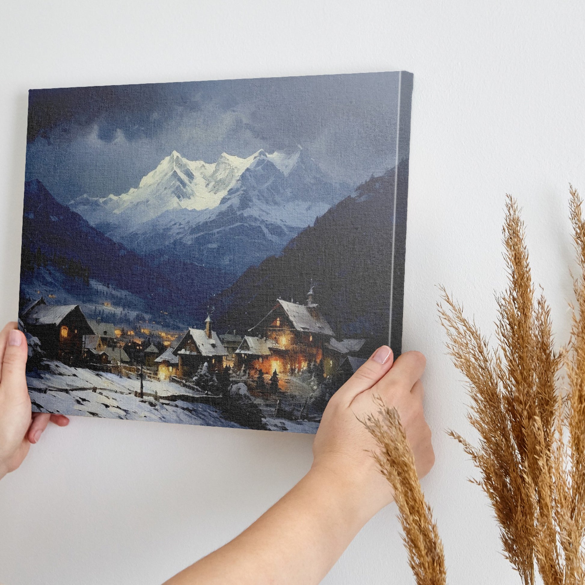 Framed canvas print of a snowy Alpine village with mountain backdrop and evening glow