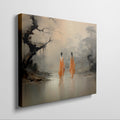 Framed canvas print of monastic figures in saffron robes by a misty river amidst autumn trees