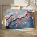 Framed canvas print of cherry blossoms with rain droplets on blue background