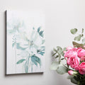 Framed canvas print of modern white floral art with soft green and pastel tones