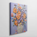 Framed canvas print of vibrant impasto-style floral bouquet with textured vase