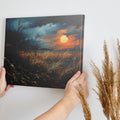 Framed canvas print of a dramatic sunset over a rustic meadow with vivid warm tones